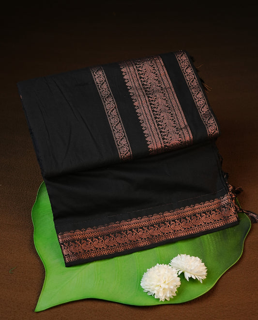 Black colour kalyani cotton saree featuring elegant plain body, complemented by self colour with Antique zari border, paired with matching blouse piece.