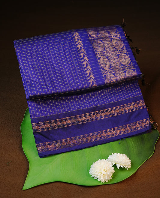 Navy blue colour kalyani cotton saree featuring gold zari strip pattern on body, complemented by self colour with Antique zari border, paired with matching blouse piece.