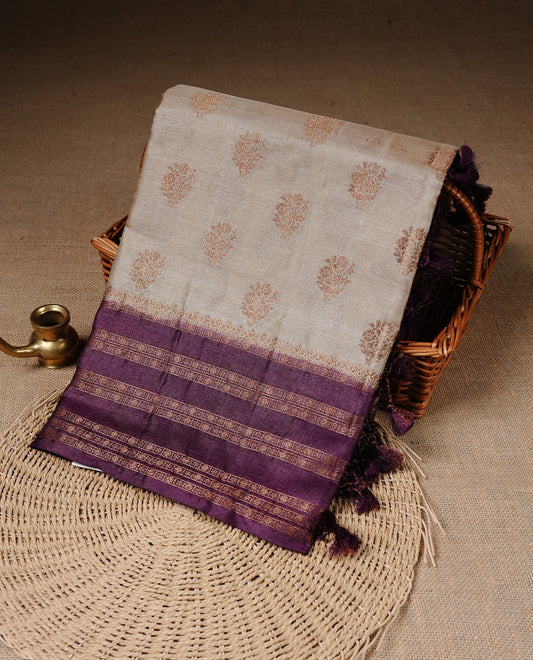 Golden Cream Colour Banaras tussar silk saree featuring Antique zari Motifs on body, Complemented by Burgundy colour variant with zari border, paired with matching blouse Piece.