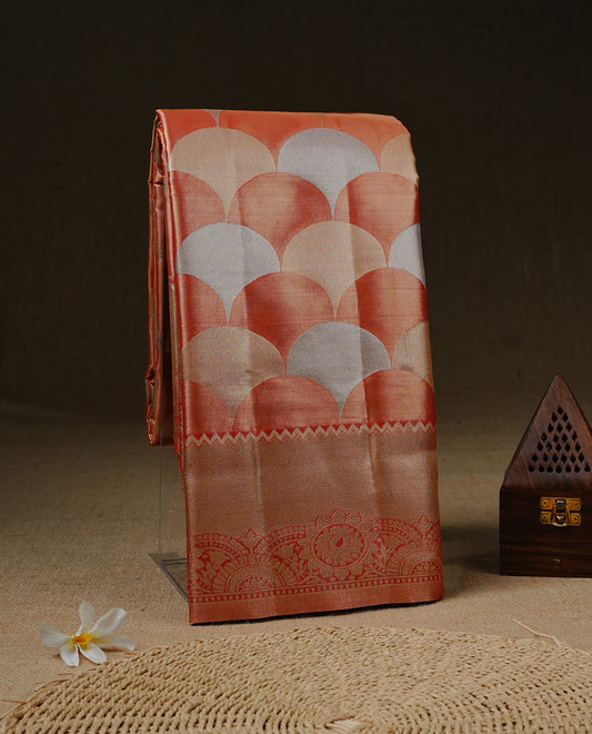 Light orange colour Tissue saree Featuring orange, Gold, silver zari Scales design on body, complemented by traditional border on self colour, paired with matching blouse piece.
