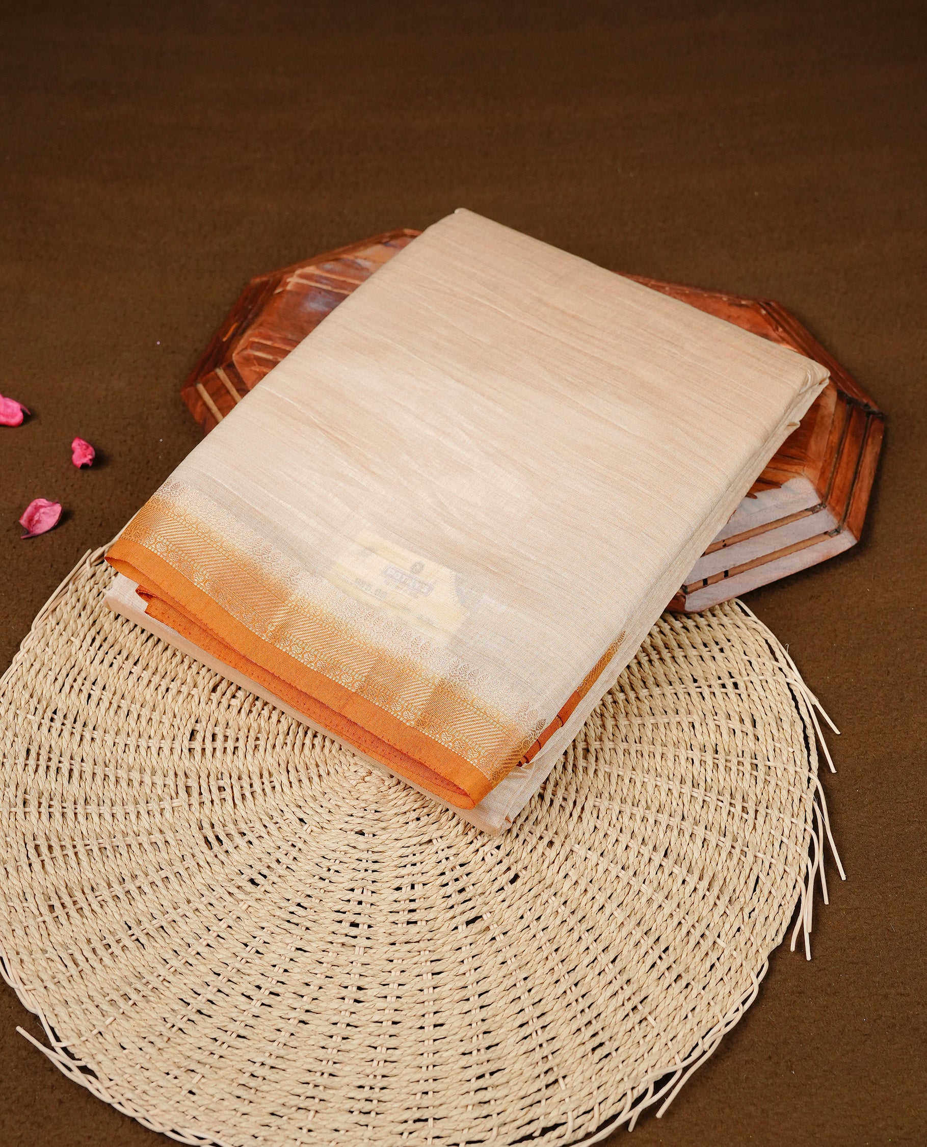 Cream colour Semi Tussar silk saree featuring an elegant plain body, accentuated by a contrast Mustard border adorned with intricate gold  zari work, paired with a matching blouse piece.
