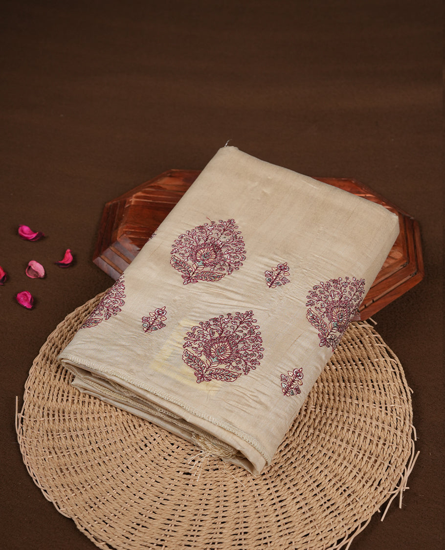 Cream colour semi tusser silk saree featuring Floral thread embroidery across body, without border and paired with matching blouse.