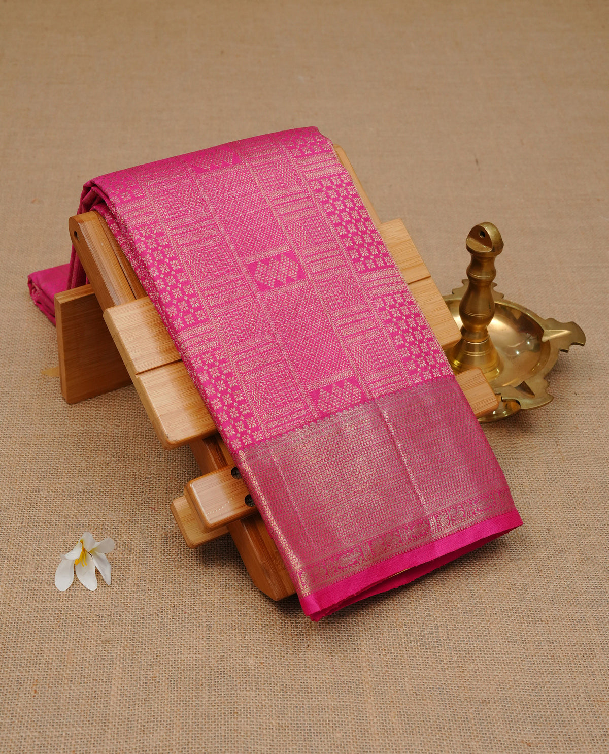 Pink colour Pure Wedding Silk Saree Featuring Gold zari Designed strips on body, complemented by self colour with traditional border, comes with matching blouse piece.