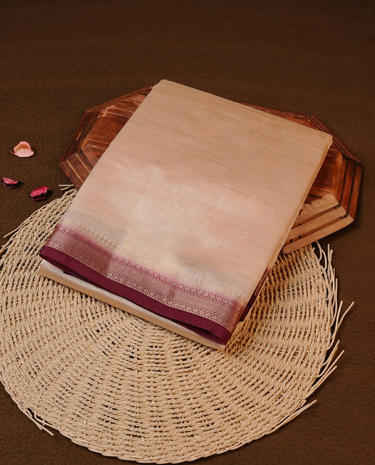 Cream colour Tussar silk saree featuring Elegant Plain body, complemented by Contrast Grape colour with gold zari border, paired with matching blouse piece.