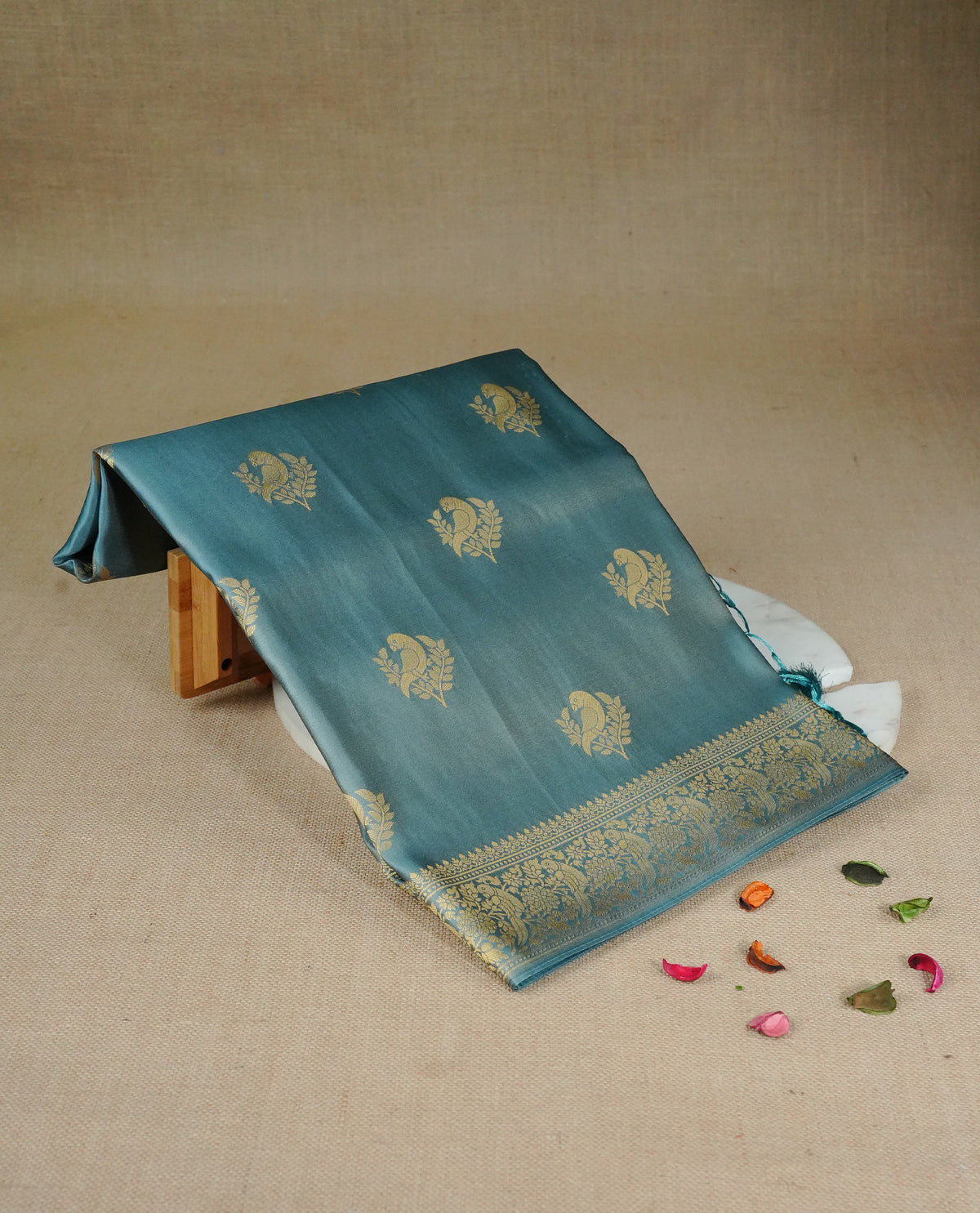 Pastel teal colour Mulberry silk saree featuring Gold zari bird motifs on body, complemented by self colour with gold zari border, comes with matching blouse piece.