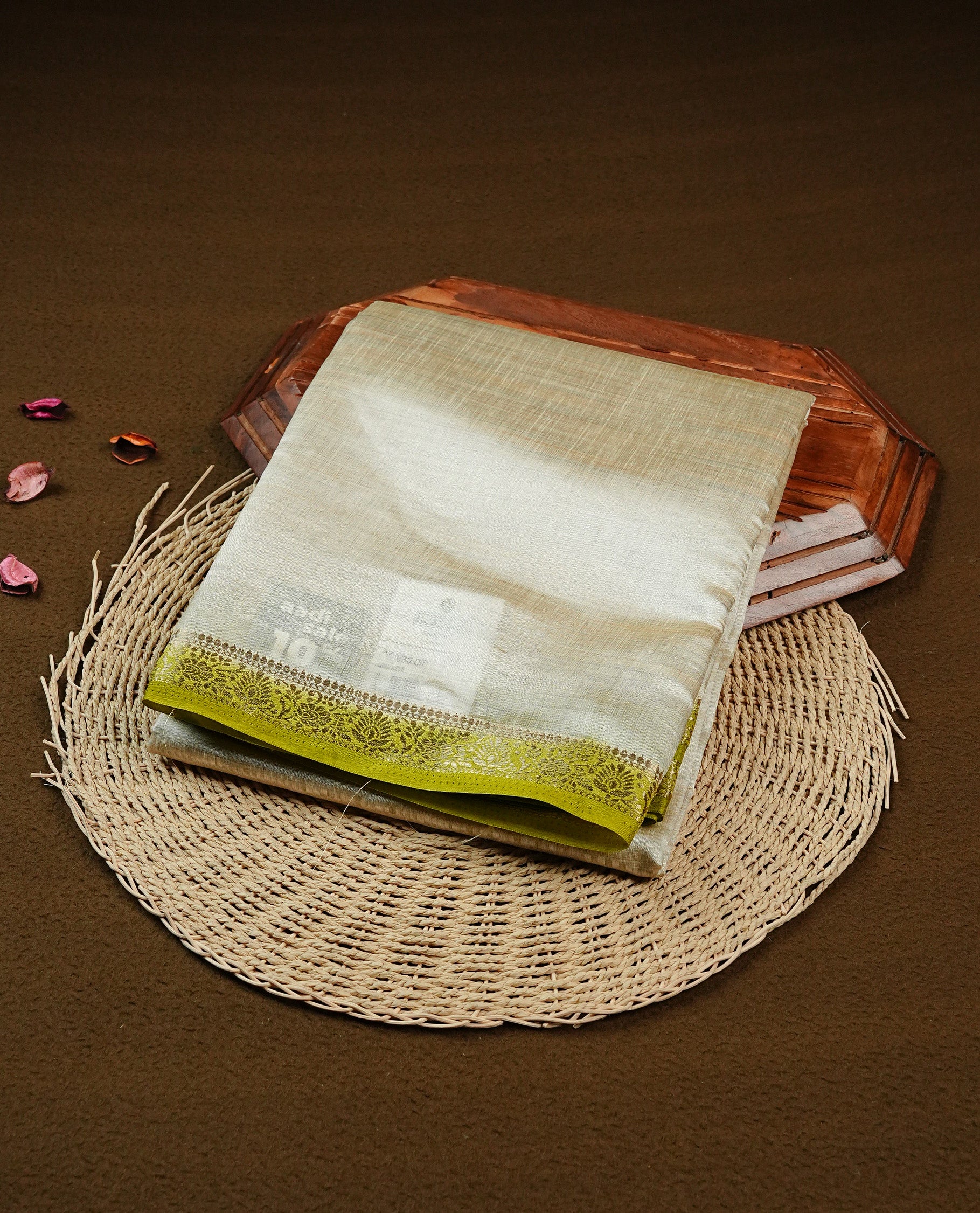 Light gold Colour Tussar saree featuring elegant plain body, complemented by contrast Olive colour with zari work border, comes with matching blouse piece.