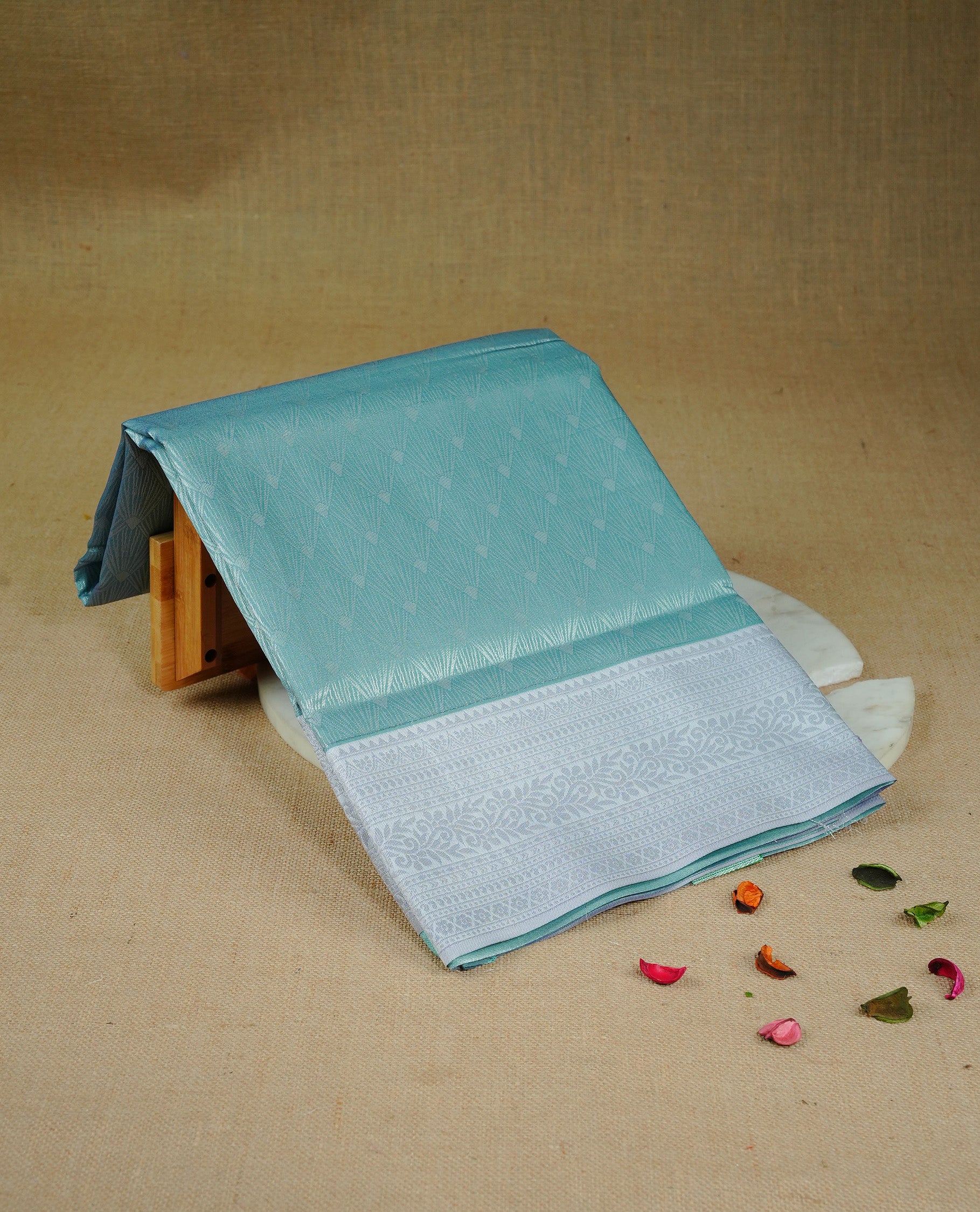 Sea green colour semi silk saree featuring Silver zari Design pattern on body, complemented by contrast Lavender colour with silver zari border, comes with matching blouse piece