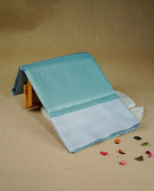 Sea green colour semi silk saree featuring Silver zari Design pattern on body, complemented by contrast Lavender colour with silver zari border, comes with matching blouse piece