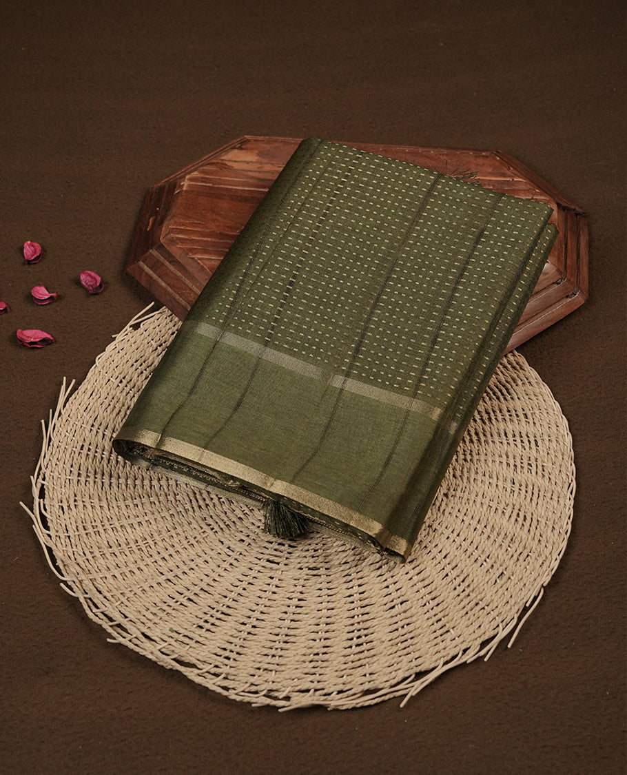 Olive green colour semi tussar silk saree highlighting gold zari dotted stripes, self colour border and contrast dark olive green pallu and comes with matching blouse piece.