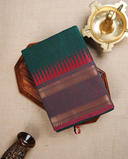Teal green colour chettinad cotton saree featuring Elegant plain body, contrast Red Temple & Faded Red With Gold zari border, paired with matching blouse piece.