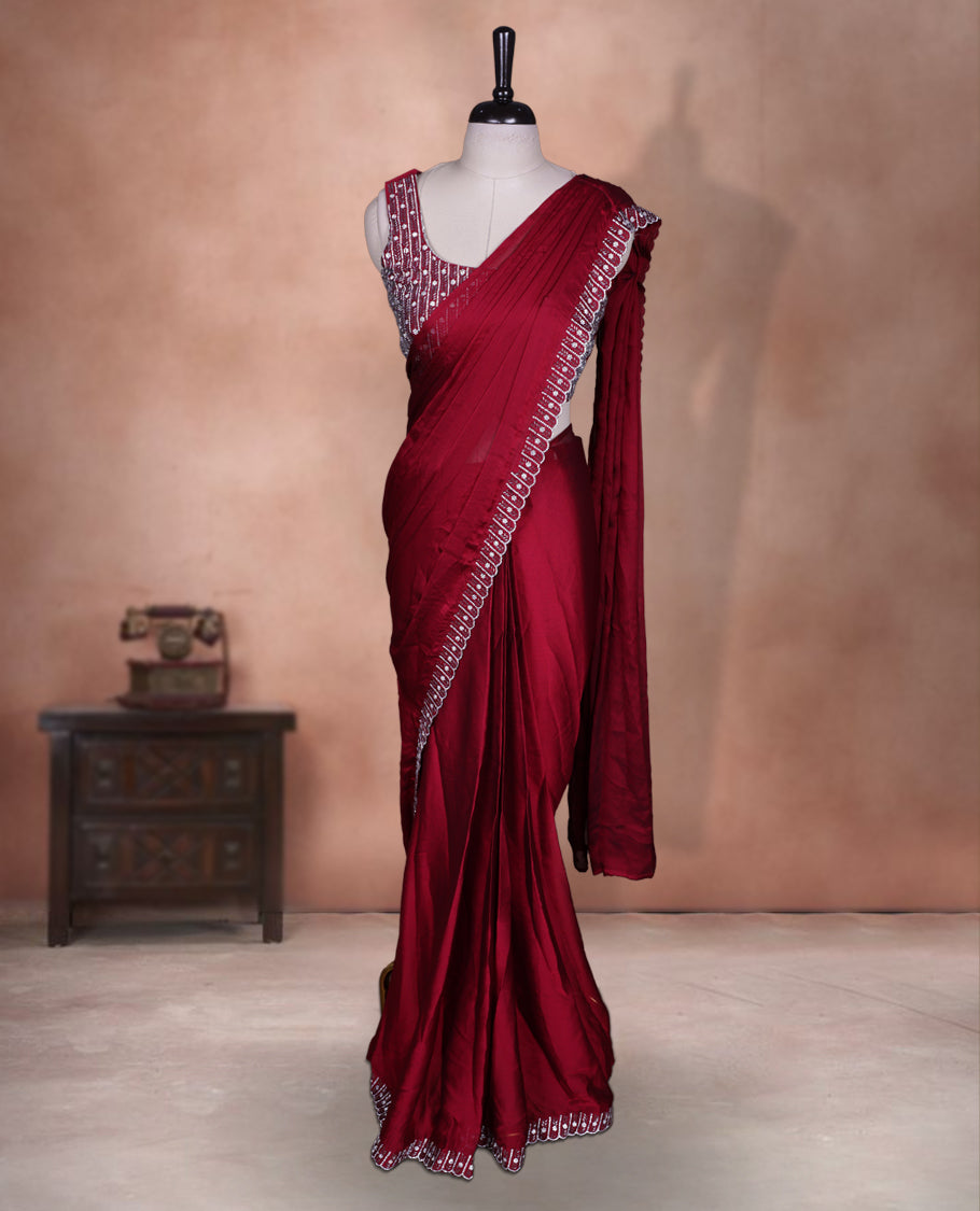 Elegant Dark red colour ready to wear saree adorned with rich White stone and bead embroidery along the border and pallu, paired with a heavily embellished matching blouse for a grand festive look.