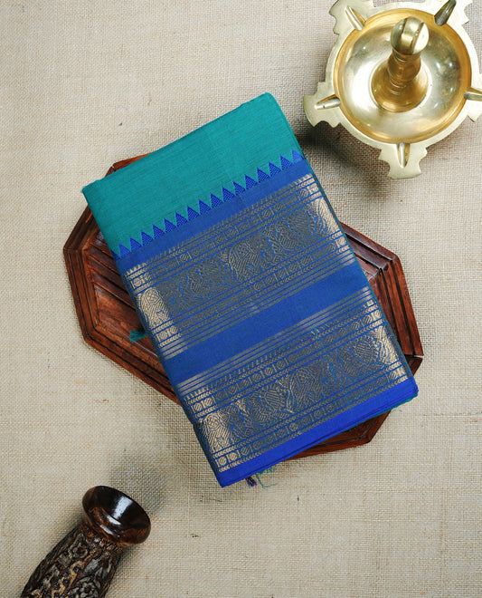 Teal Green colour chettinad cotton saree featuring  Plain body, complemented by Contrast Blue Colour With Traditional Gold Zari border, paired with matching blouse piece.