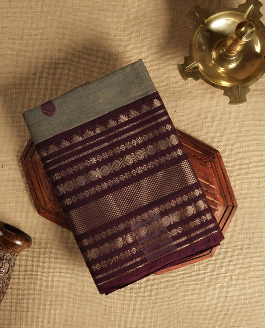 Grey and maroon dual shaded Chettinad cotton saree featuring intricate zari weaving all over the body, Enhanced with a rich maroon zari border and pallu, giving it a traditional and regal appeal & Comes with a matching blouse piece.