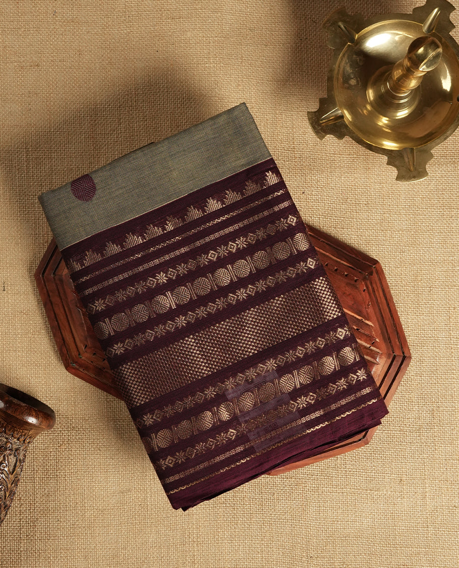 Grey and maroon dual shaded Chettinad cotton saree featuring intricate zari weaving all over the body, Enhanced with a rich maroon zari border and pallu, giving it a traditional and regal appeal & Comes with a matching blouse piece.