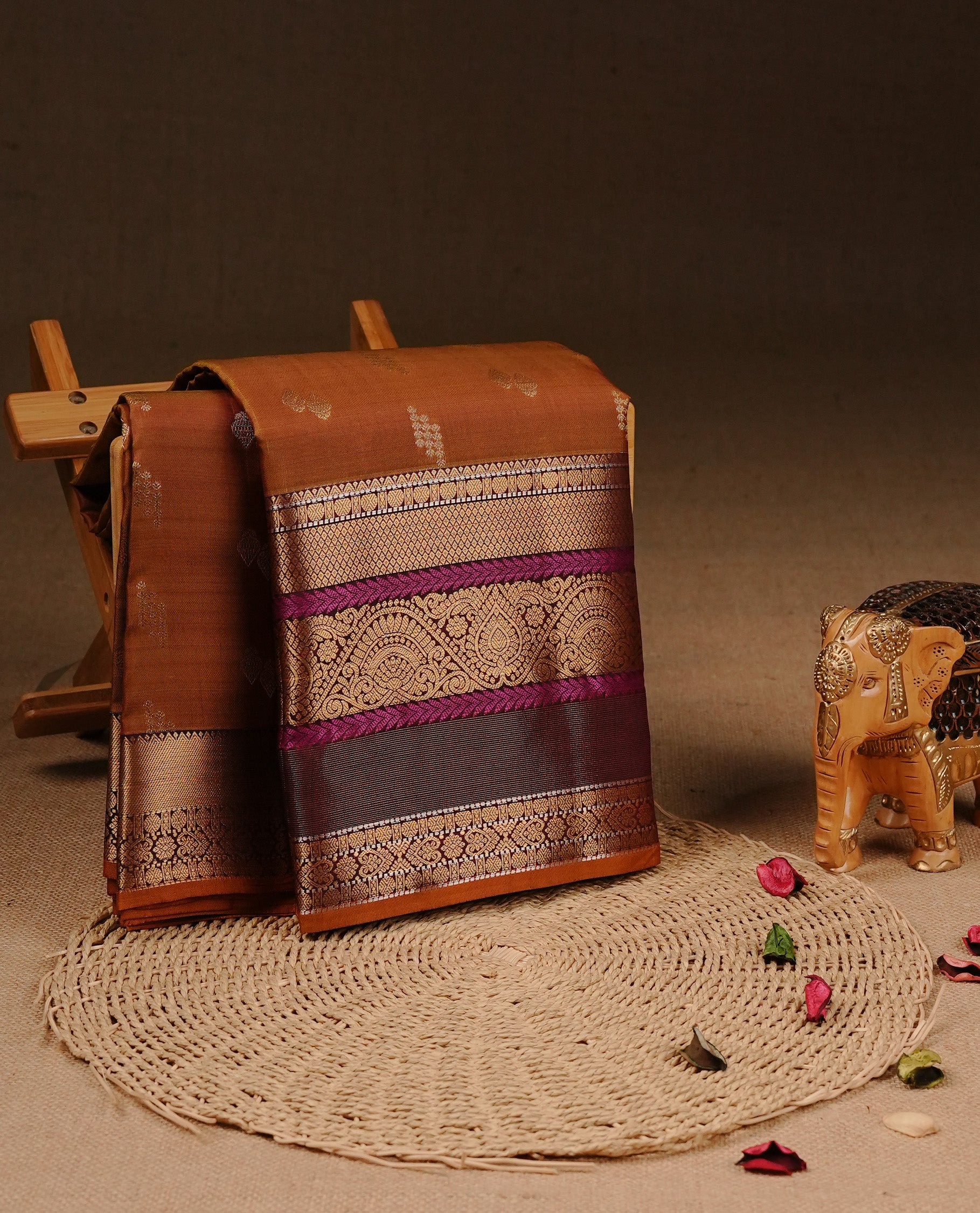 Olive Colour Traditional Kancheepuram Silk Saree Featuring Gold Zari Motifs on Body, Complemented By Self colour with Traditional zari & purple border, paired with matching blouse piece.
