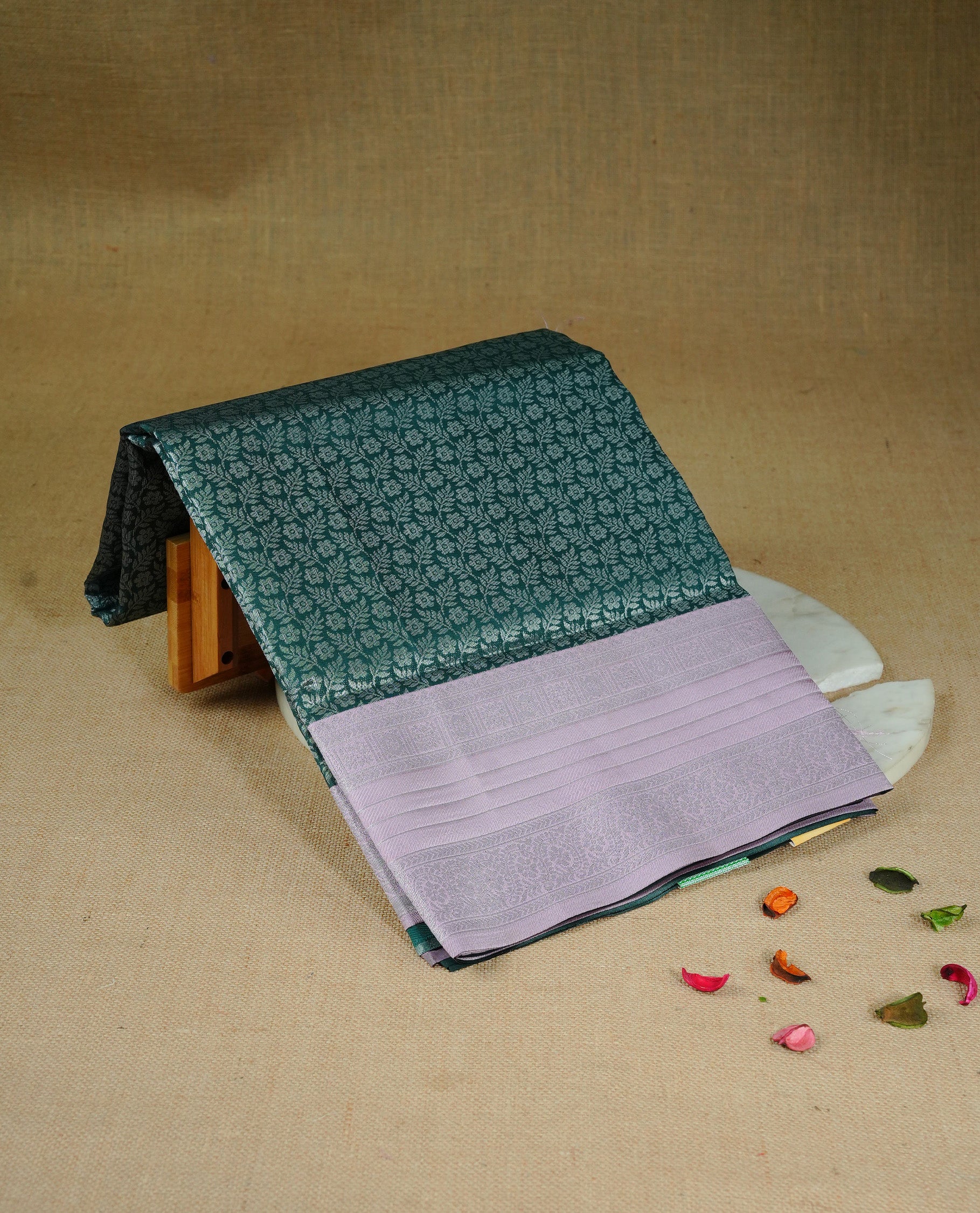 Green colour semi silk saree featuring Silver zari Floral pattern on body, complemented by contrast Pink colour with silver zari border, comes with matching blouse piece.