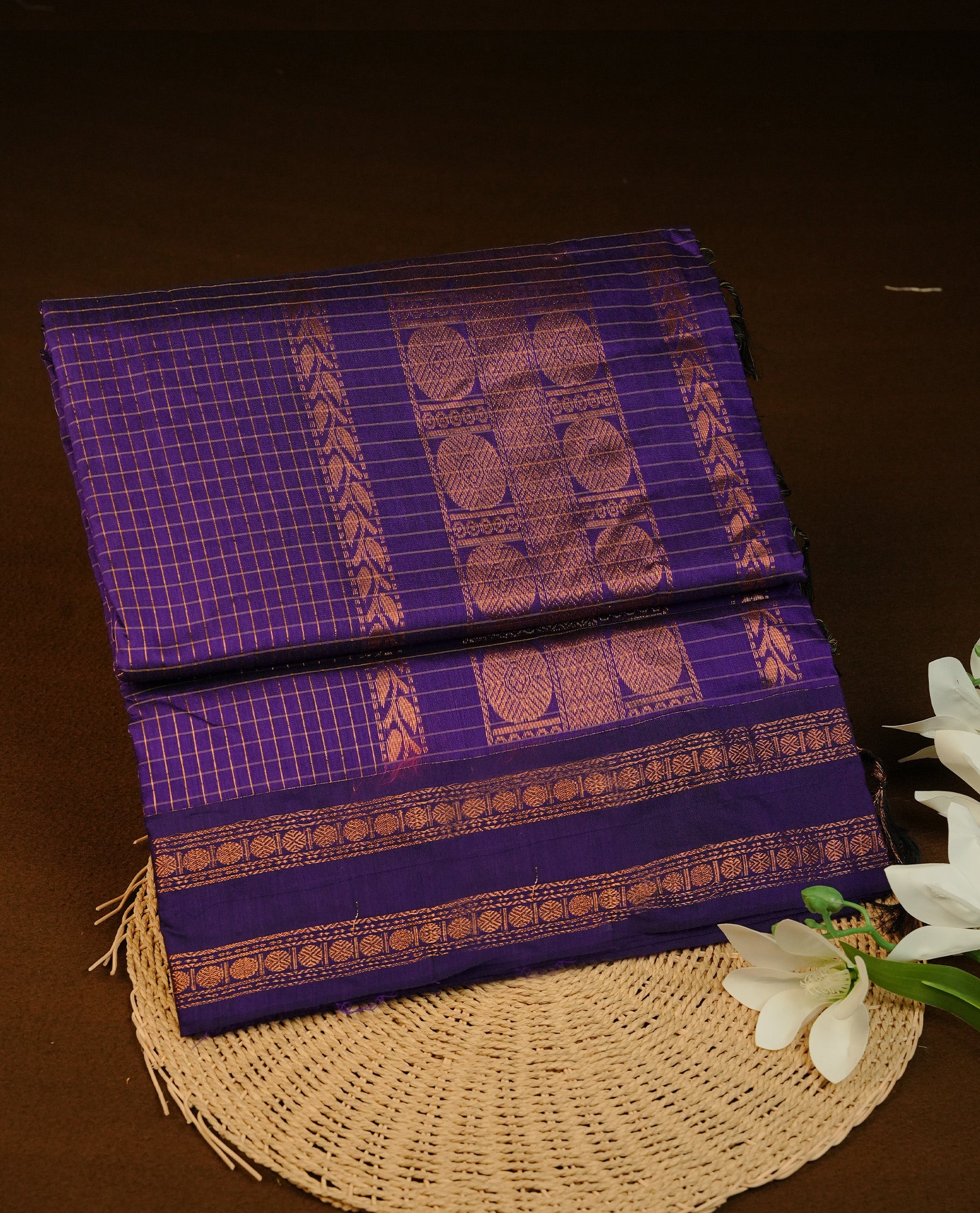 Indigo colour Kalyani cotton featuring Gold zari Check pattern on body, complemented by Self colour With gold zari grand border & pallu, matching blouse piece.