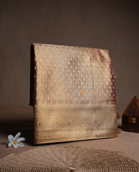 Gold colour tissue banaras silk saree featuring antique gold zari motifs on the body with rich traditional zari border and pallu, paired with a matching blouse piece.