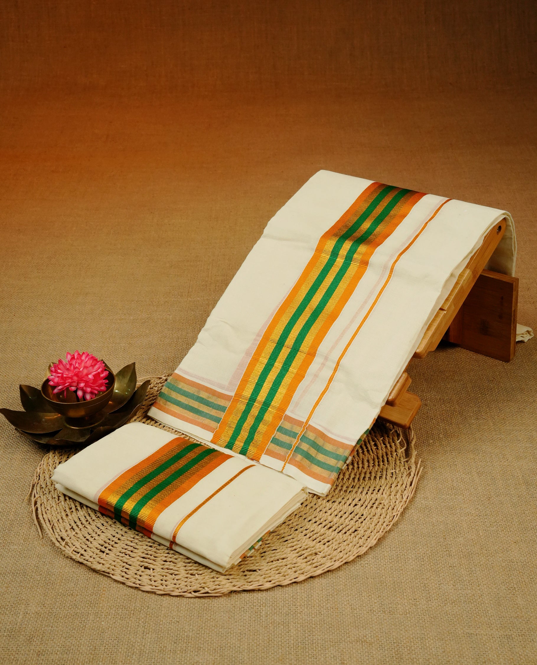 Cream colour cotton Set Mundu With Plain body, enhanced with Gold kasavu with orange & green kara.