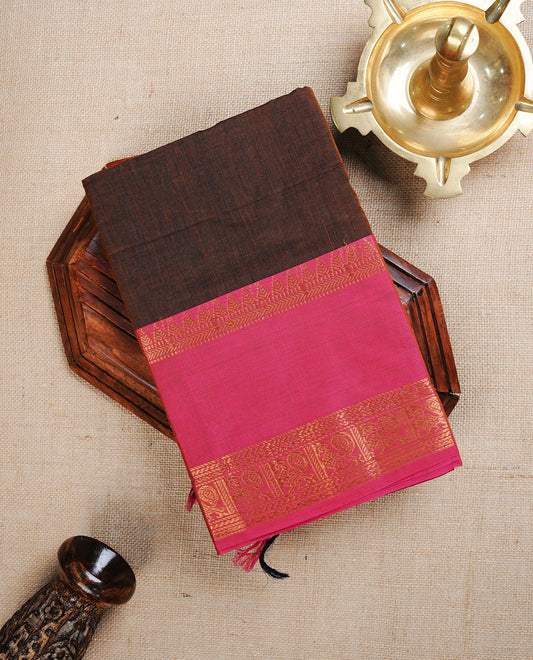 Brown colour chettinad cotton saree featuring Elegant plain body, complemented by contrast Magenta With Gold zari Border, paired with Matching blouse piece.