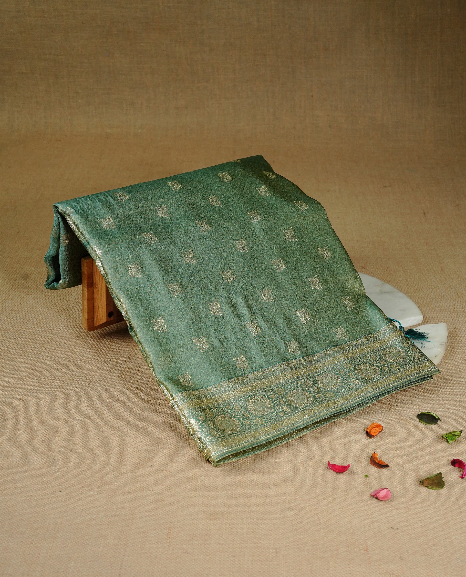 Teal colour Mulberry silk saree featuring gold zari motifs on body, complemented by contrast self colour with gold zari border, comes with matching blouse piece.