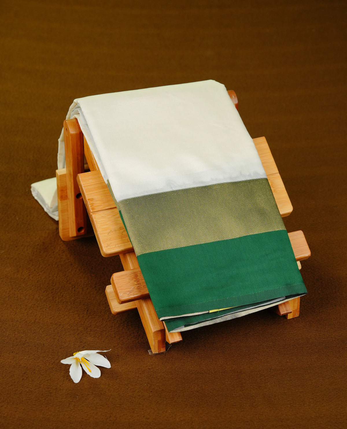 Off White colour soft silk saree with contrast Green border.