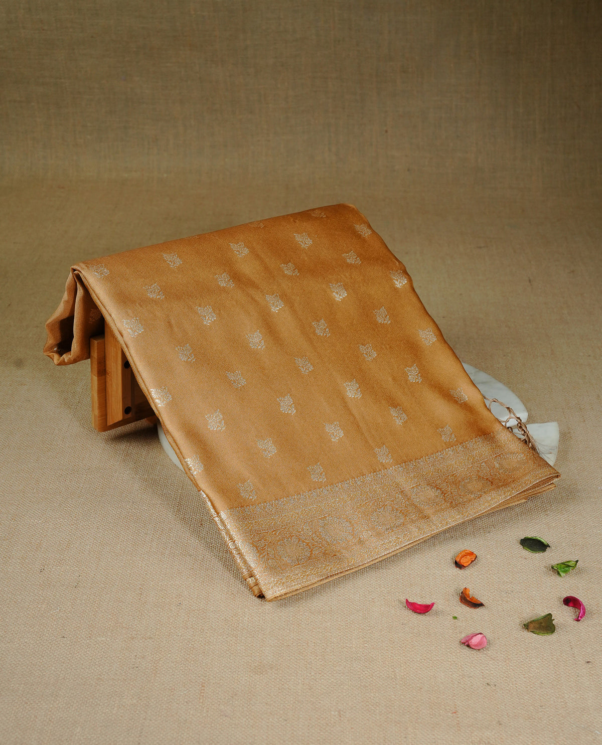 Golden beige colour Mulberry silk saree featuring gold zari motifs on body, complemented by contrast self colour with gold zari border, comes with matching blouse piece.