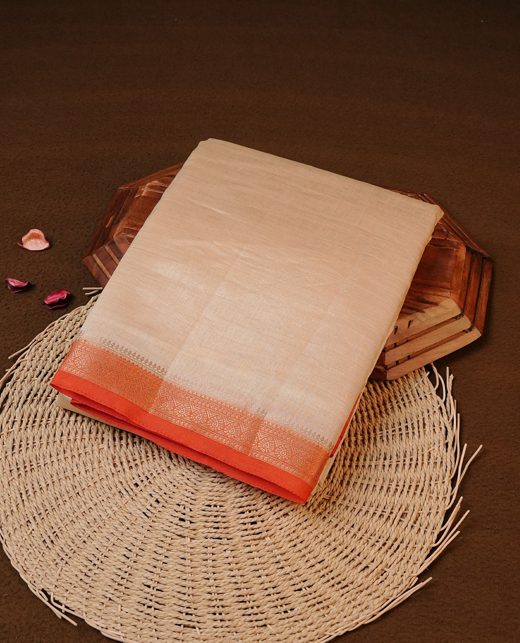 Cream colour Tussar silk saree Featuring Elegant Plain body, complemented by Contrast Orange colour with gold zari border, paired with matching blouse piece.