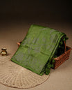 Olive green colour banaras saree featuring Antique zari kodi pattern on body, complemented by Zari pattern on self colour border, comes with matching blouse piece.