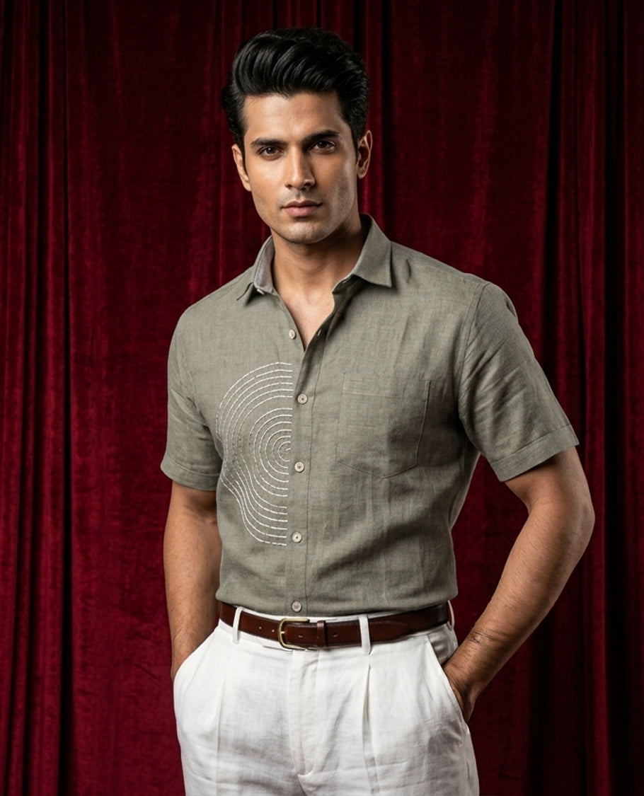 Grey colour shirt designed with thread pattern on body, adored with half sleeve.