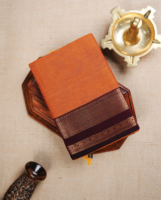 Rust Orange colour chettinad cotton saree featuring  Plain body, complemented by Contrast Maroon Colour With Gold Zari border, paired with matching blouse piece.