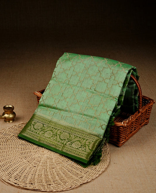 Light green colour Banaras silk saree featuring gold zari Geometric pattern on body, complemented by contrast green colour with zari border, comes with matching blouse piece.