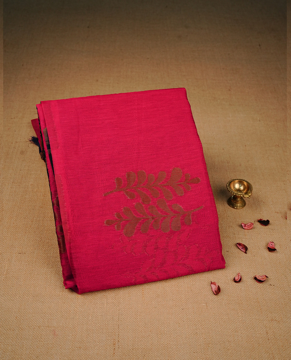 Red colour semi silk saree featuring Gold zari Leaf pattern on body, complemented by contrast  navy colour with Gold zari border, comes with matching blouse piece.