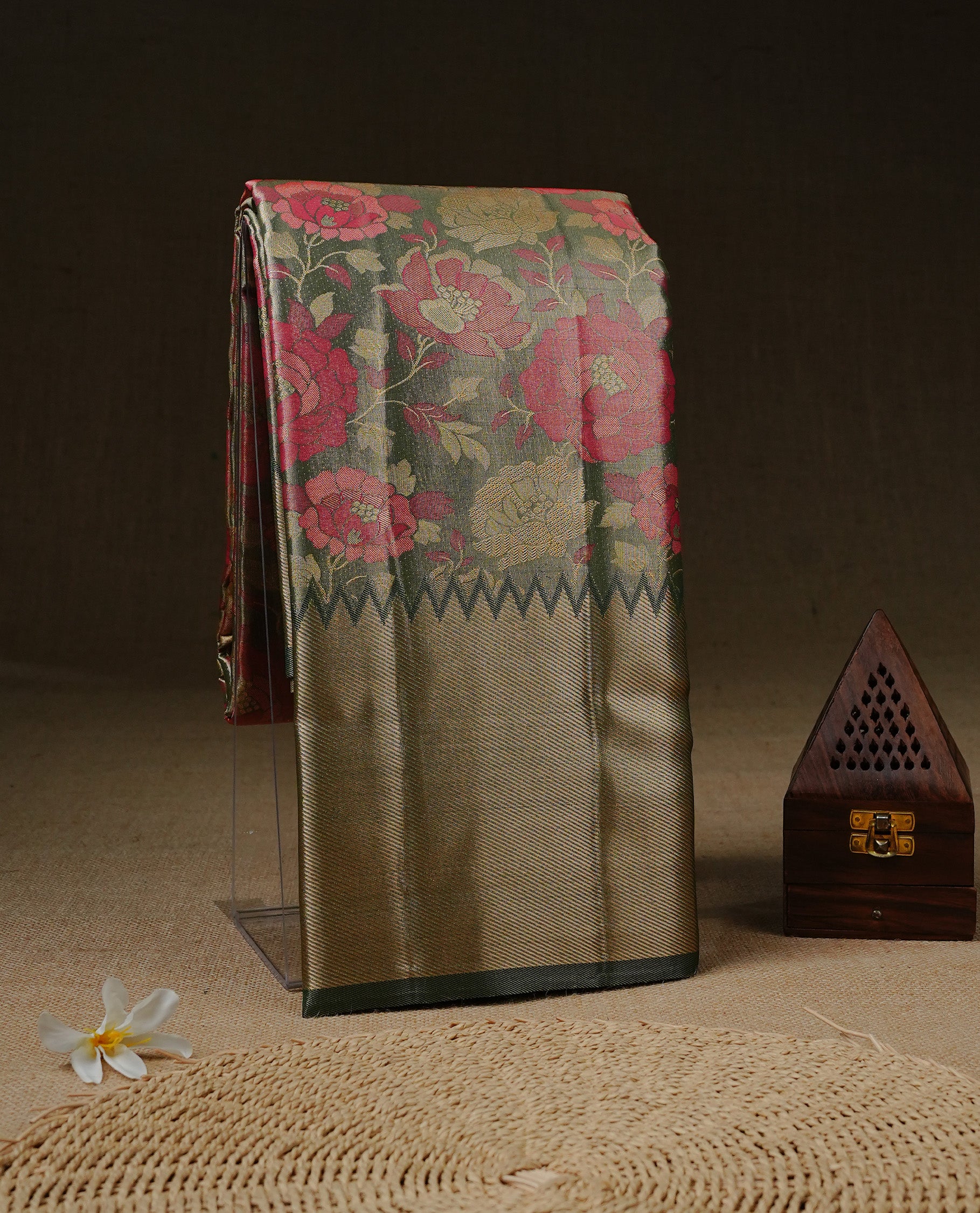 Light green colour Tissue silk saree featuring Pink colour floral zari motifs on body, complemented by contrast Light green with gold zari border, paired with matching blouse piece.
