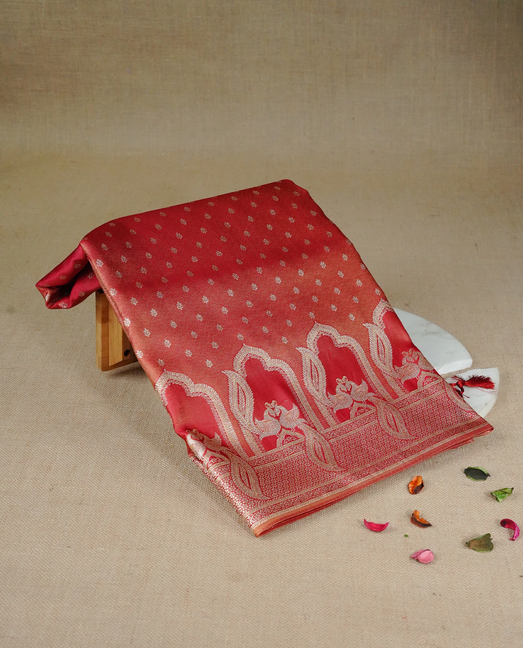 Red colour Mulberry silk saree featuring Gold zari buttas on body, complmented by self colour with Gold zari dual peacock in Temple design border, comes with matching blouse piece.