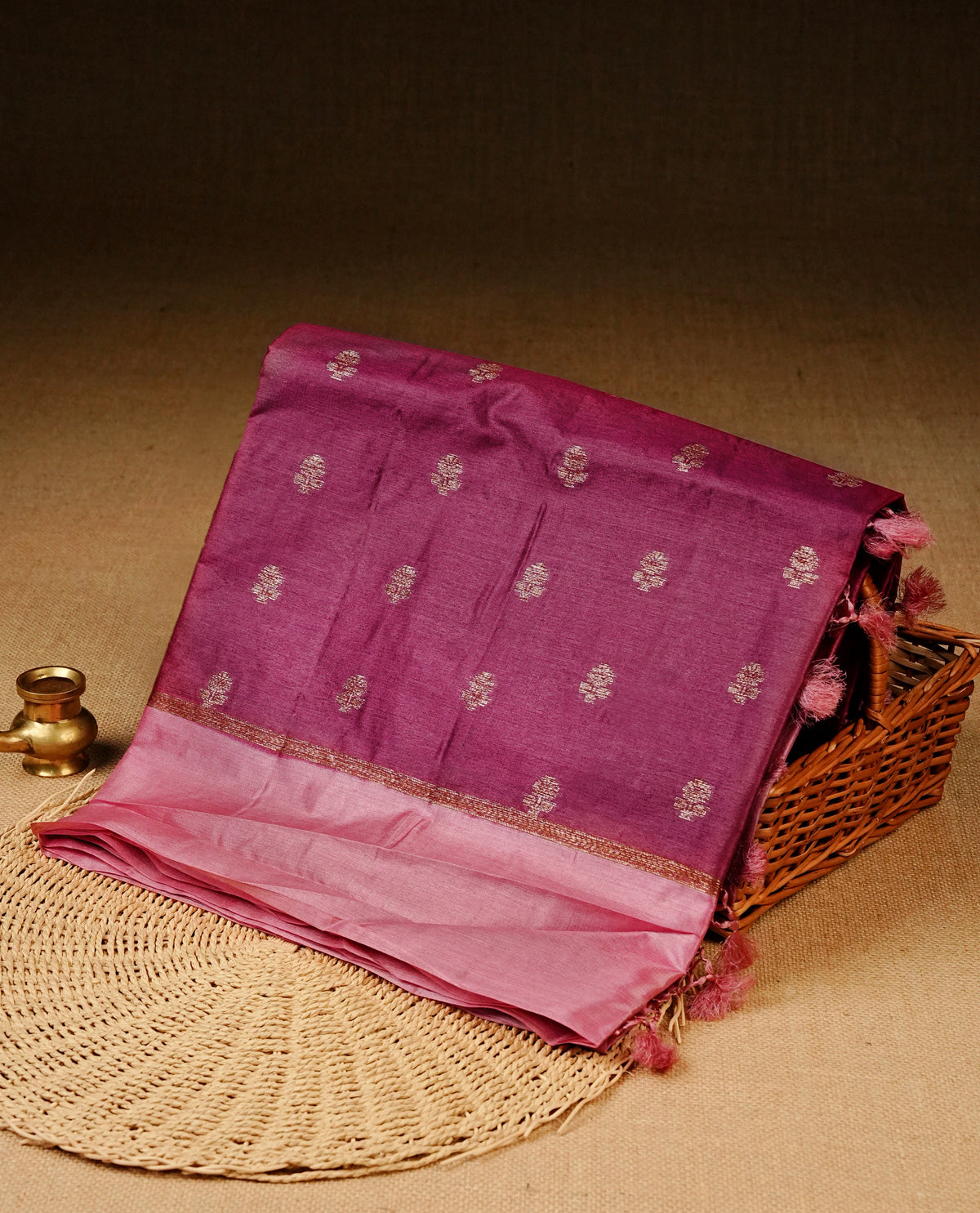 Grape colour banaras silk saree featuring Gold zari buttas on body, complemented by contrast light pink colour border, comes with matching blouse piece.
