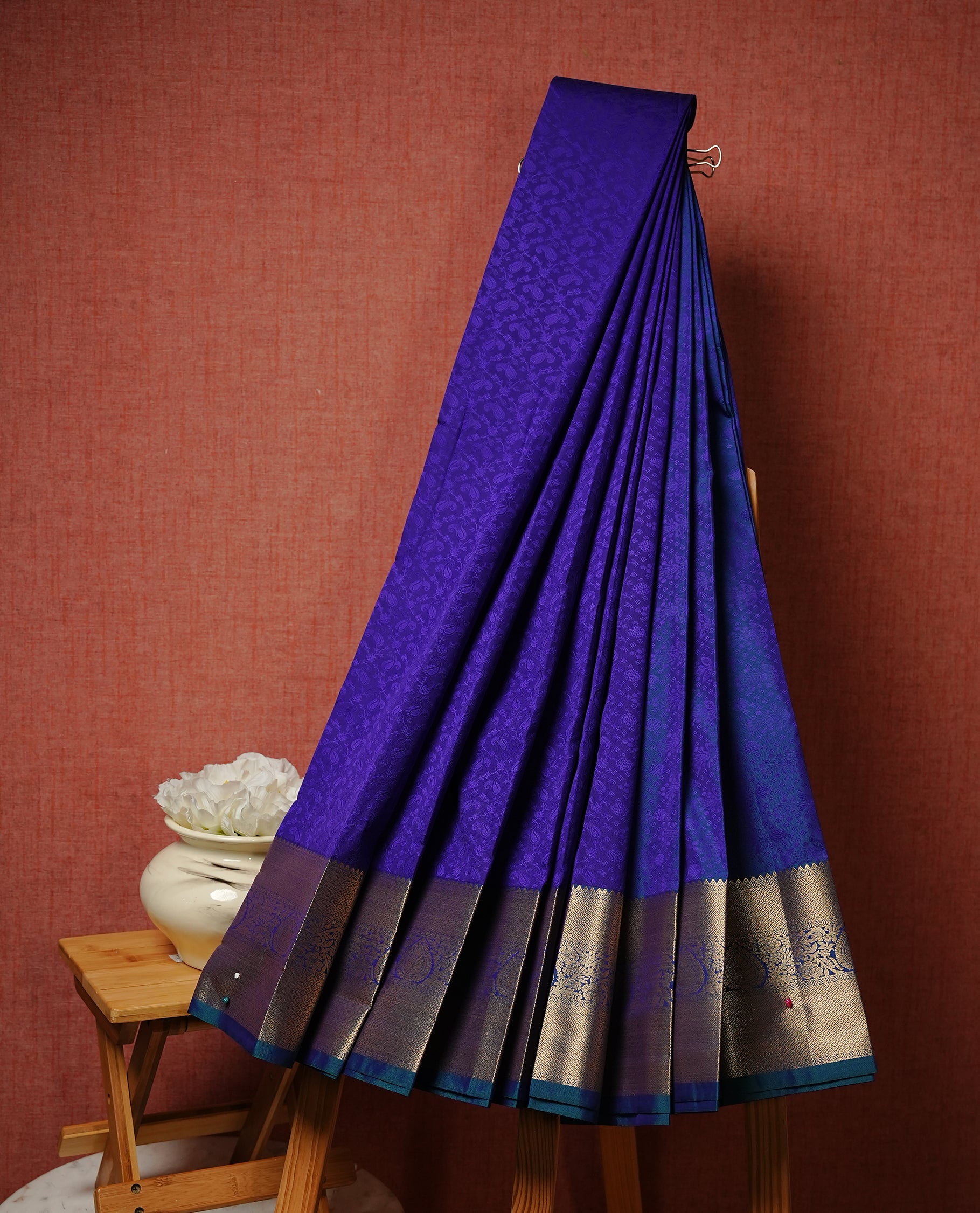 Indigo colour Semi silk saree Featuring selfcolour zari pattern on body, complemented by contrast Teal colour with gold zari border, paired with matching blouse piece.
