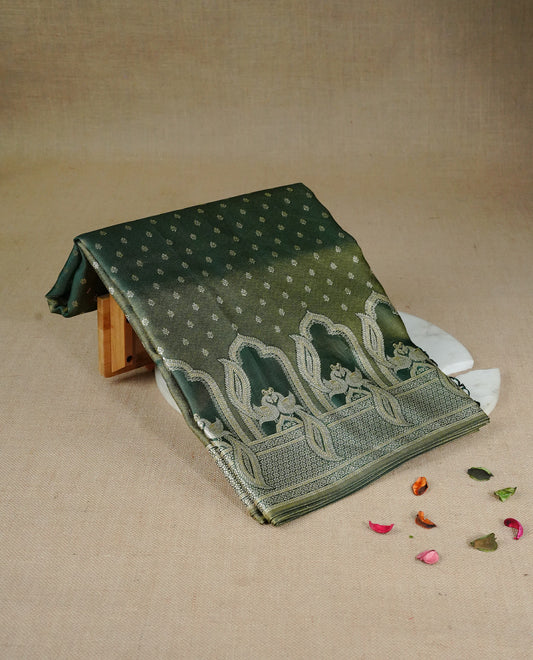 Green colour Mulberry silk saree featuring Gold zari buttas on body, complmented by self colour with Gold zari dual peacock in Temple design border, comes with matching blouse piece.