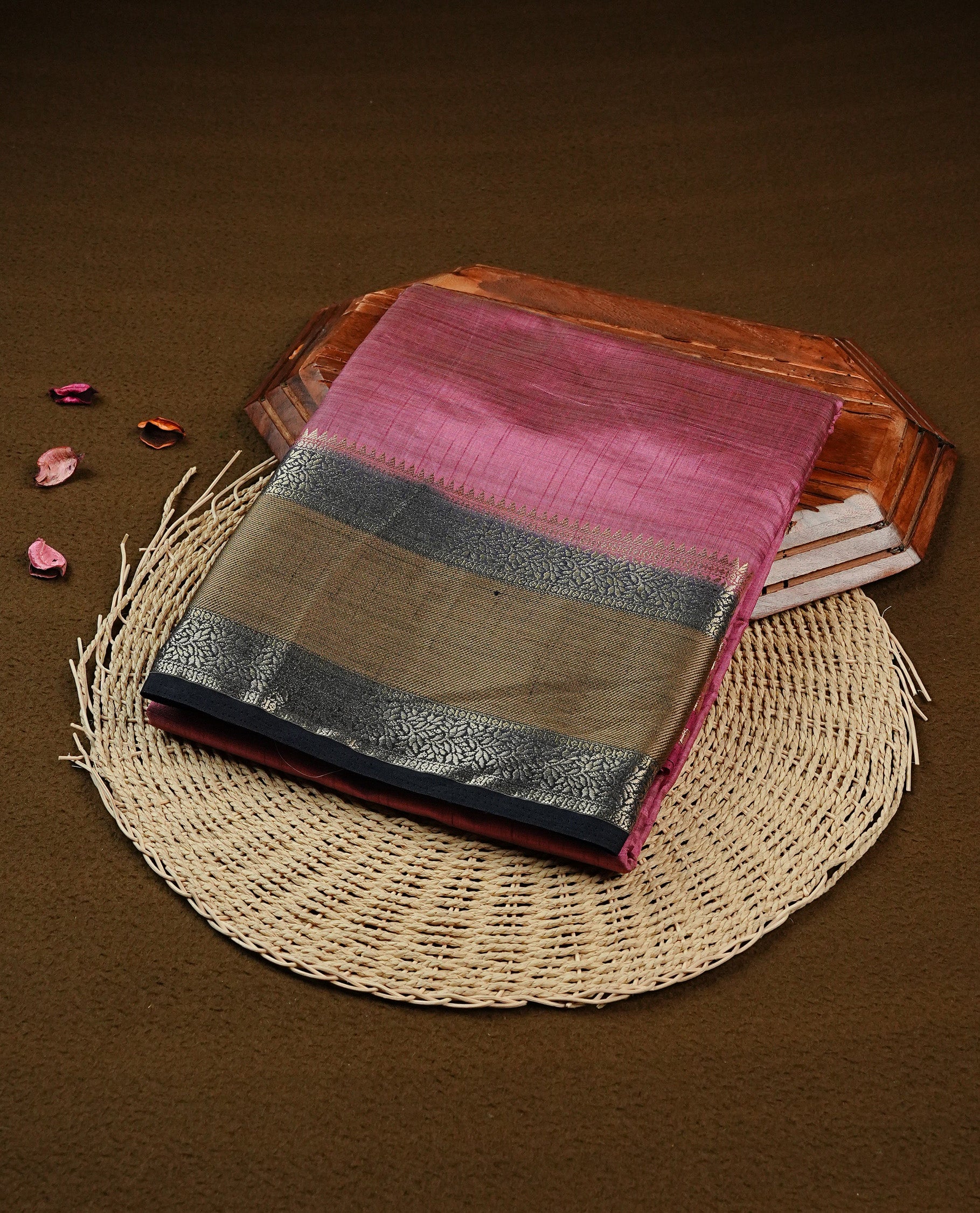 Mauve colour Tussar saree featuring Gold zari buttas on body, complemented by contrast Black & olive Colour with Gold zari border, comes with matching blouse piece.