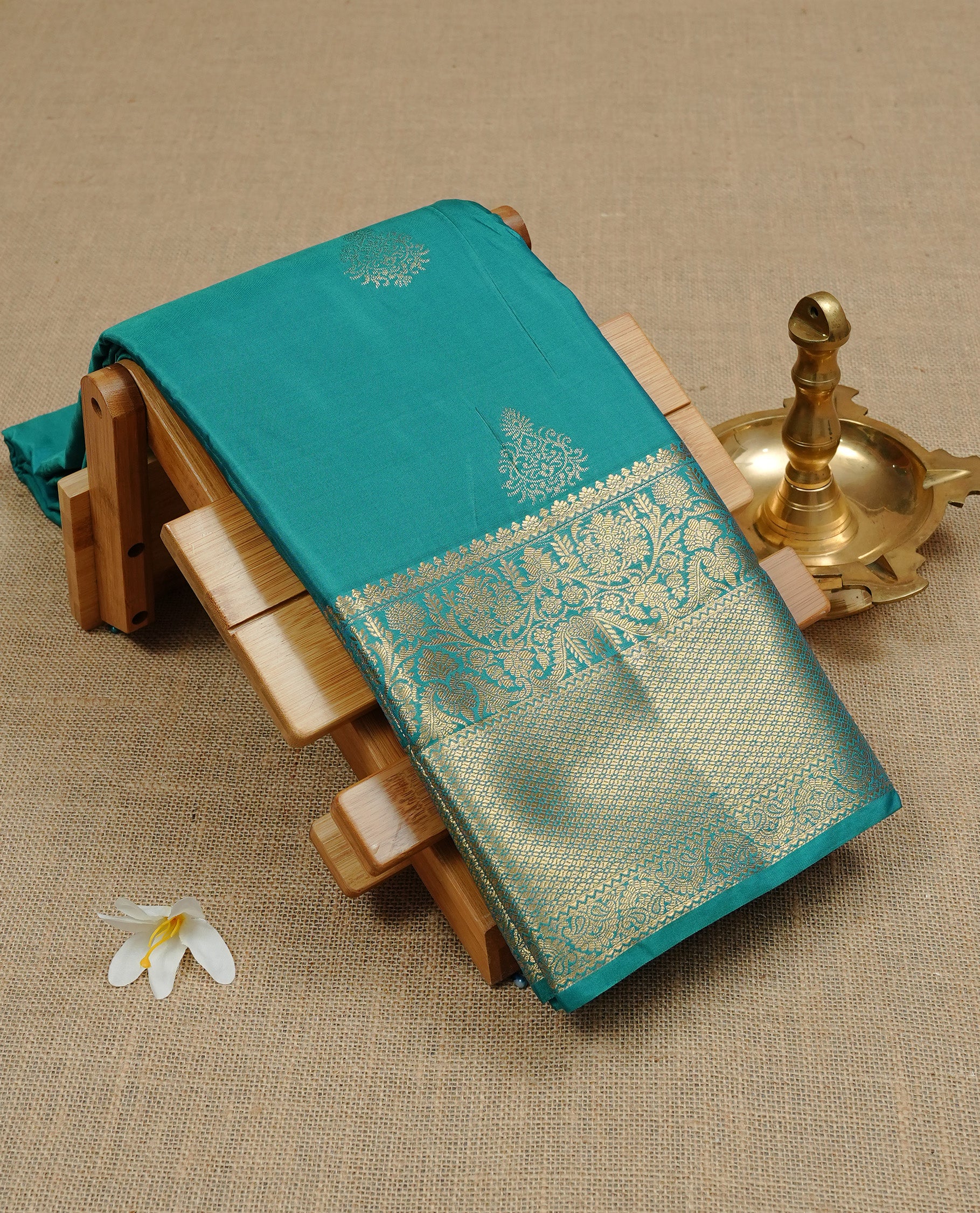 Cadmium Green Semi Wedding Silk Saree featuring Gold Zari Motifs On body, Complemented with traditional zari with Self colour border, paired with matching blouse piece.