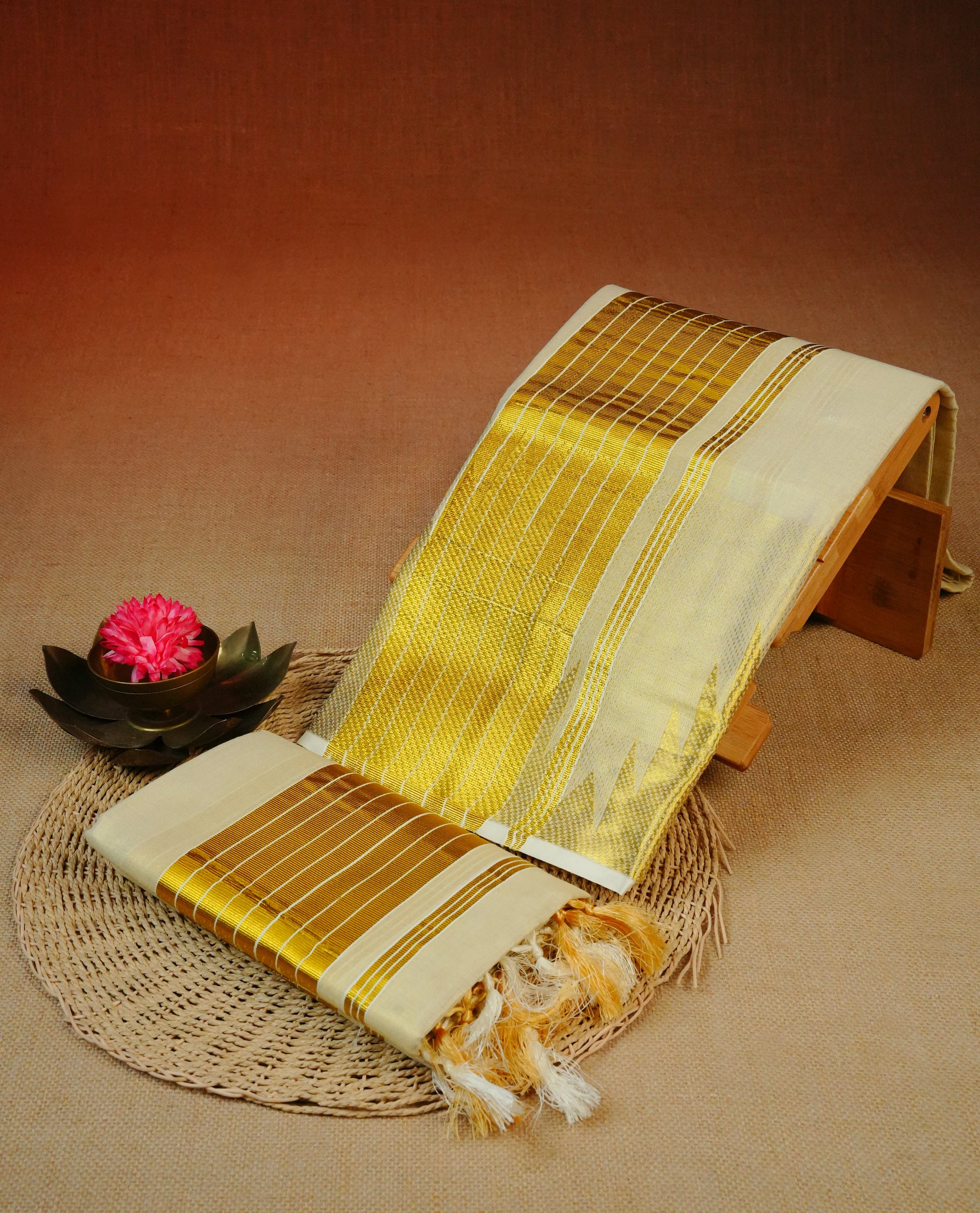 Cream Colour  tissue set mundu featuring a plain body, enhanced with Temple Border & a Striped gold zari kara.