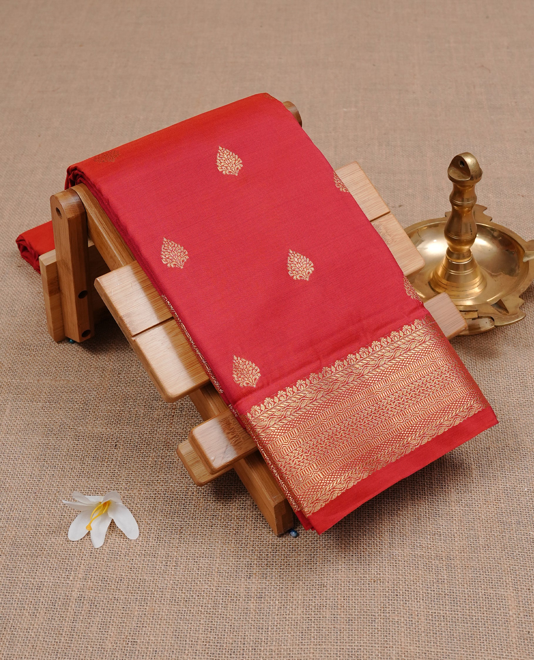 Red Semi Wedding Silk Saree featuring Gold Zari Motifs On body, Complemented with traditional zari with Self colour border, paired with matching blouse piece.