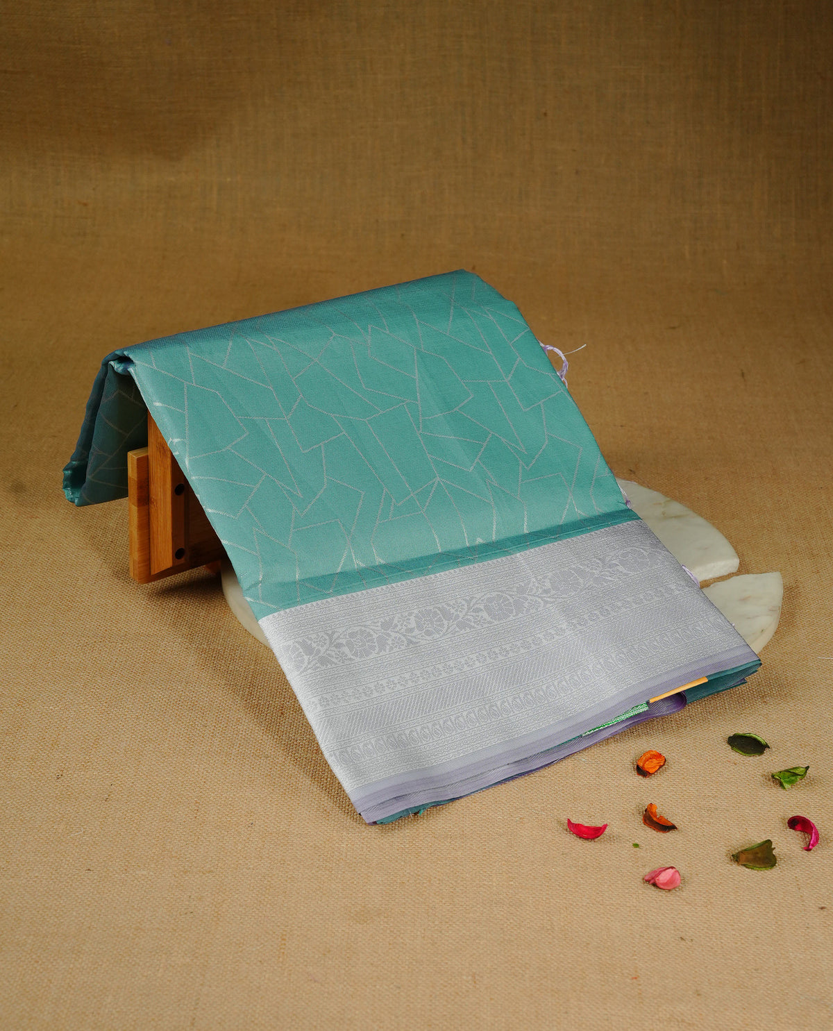 Sea green colour semi silk saree featuring Silver zari Geometric pattern on body, complemented by contrast Lavender colour with silver zari border, comes with matching blouse piece.