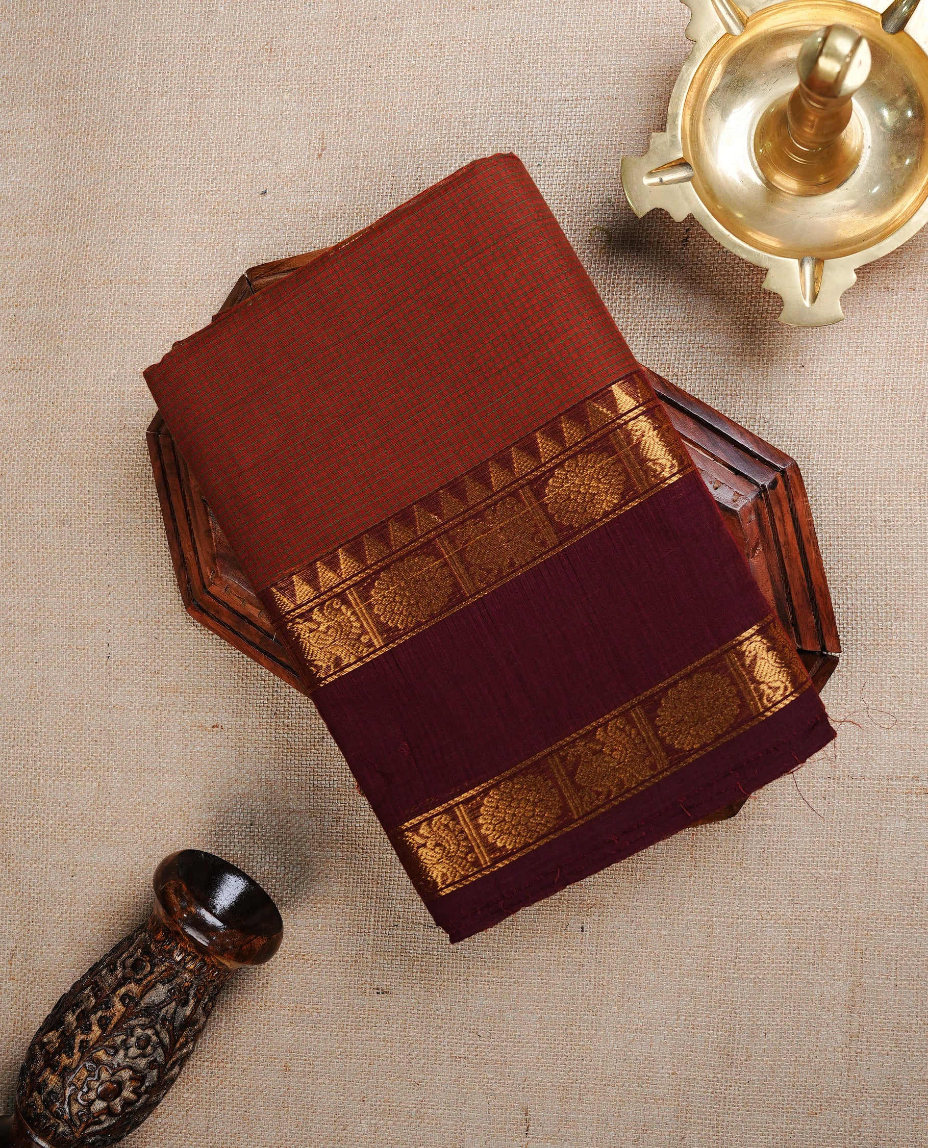 Light brown colour chettinad cotton saree featuring Green small check pattern on body, complemented by contrast Brown colour with Gold zari border, paired with matching blouse piece.