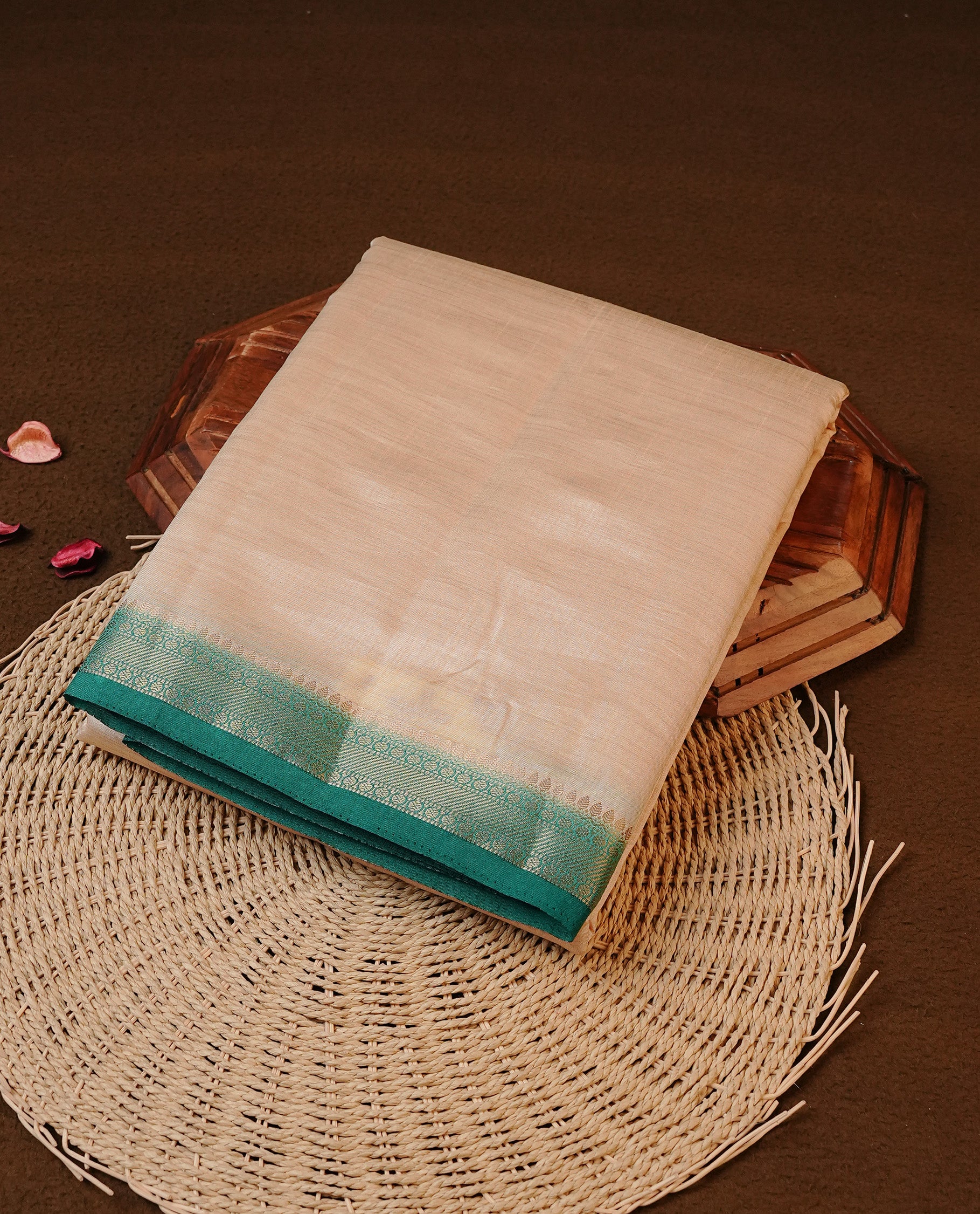 Cream colour Tussar silk saree featuirng Elegant Plain body, complemented by Contrast Green colour with gold zari border, paired with matching blouse piece.