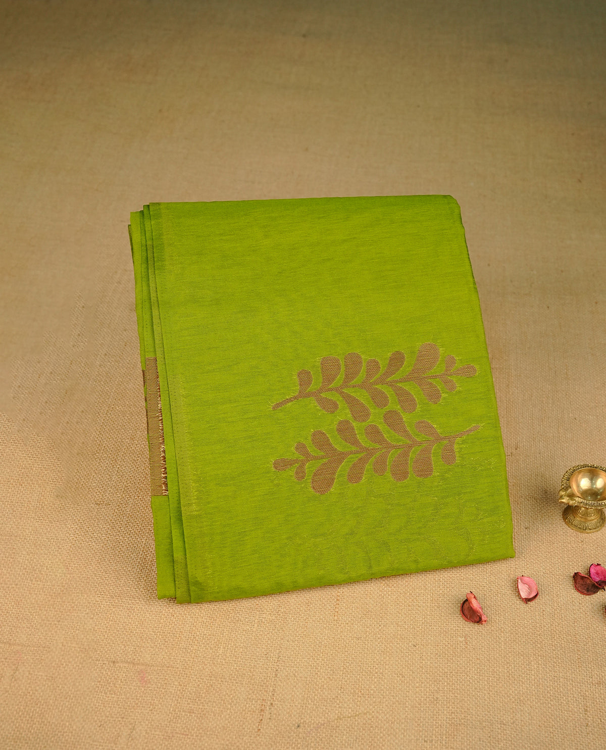 Green colour semi silk saree featuring Gold zari Leaf pattern on body, complemented by contrast colour with Gold zari border, comes with matching blouse piece.