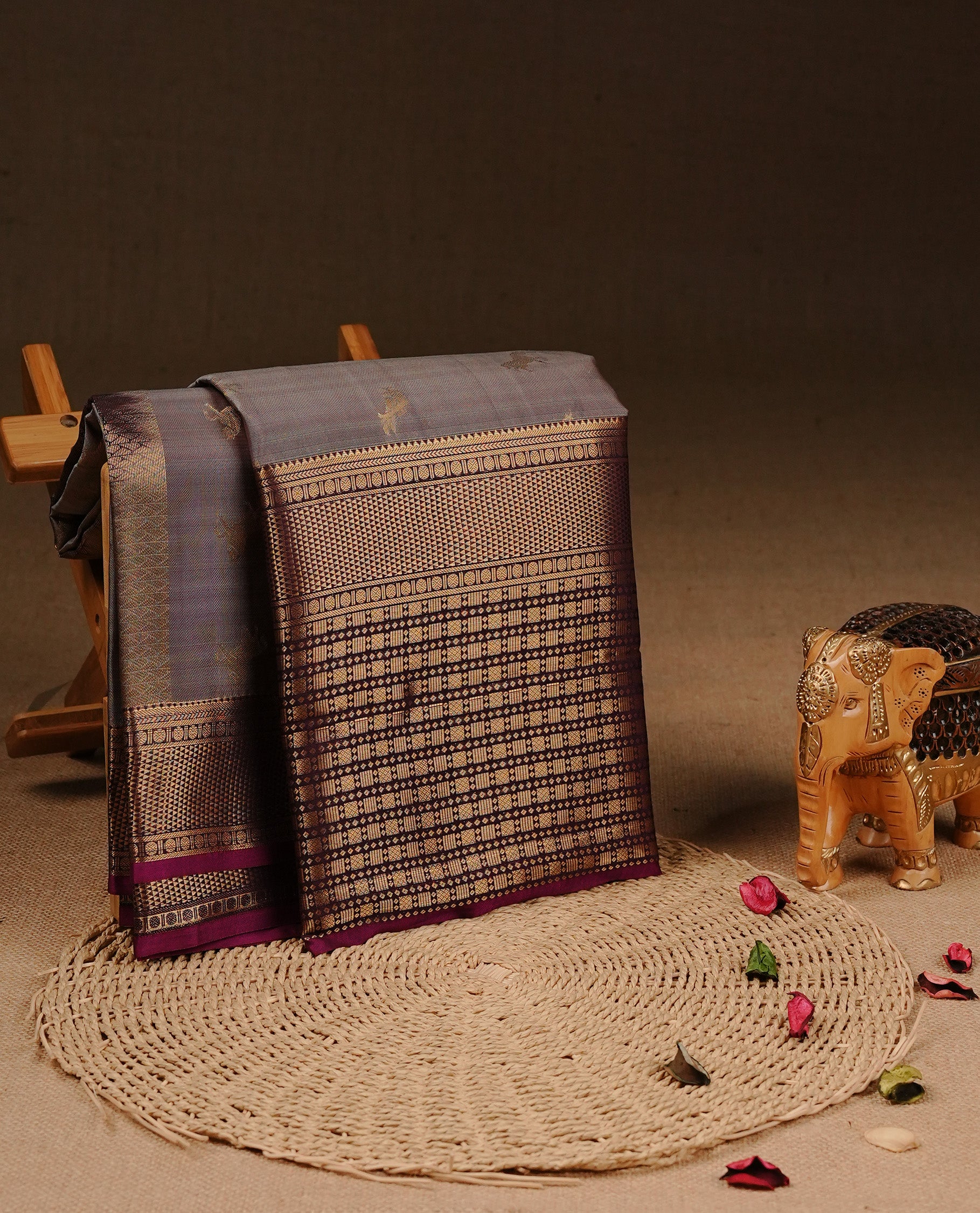Grey colour Traditional Kancheepuram silk saree featuring gold zari motifs on body, enhanced with contrast Purple with traditional border, paired with matching blouse piece.