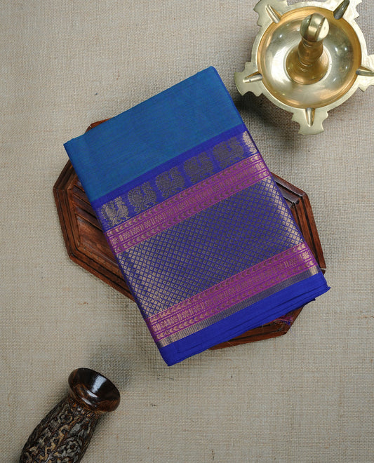 Peacock colour chettinad cotton saree featuring  Plain body, complemented by Violet & Pink Colour With  Gold Zari border, paired with matching blouse piece.