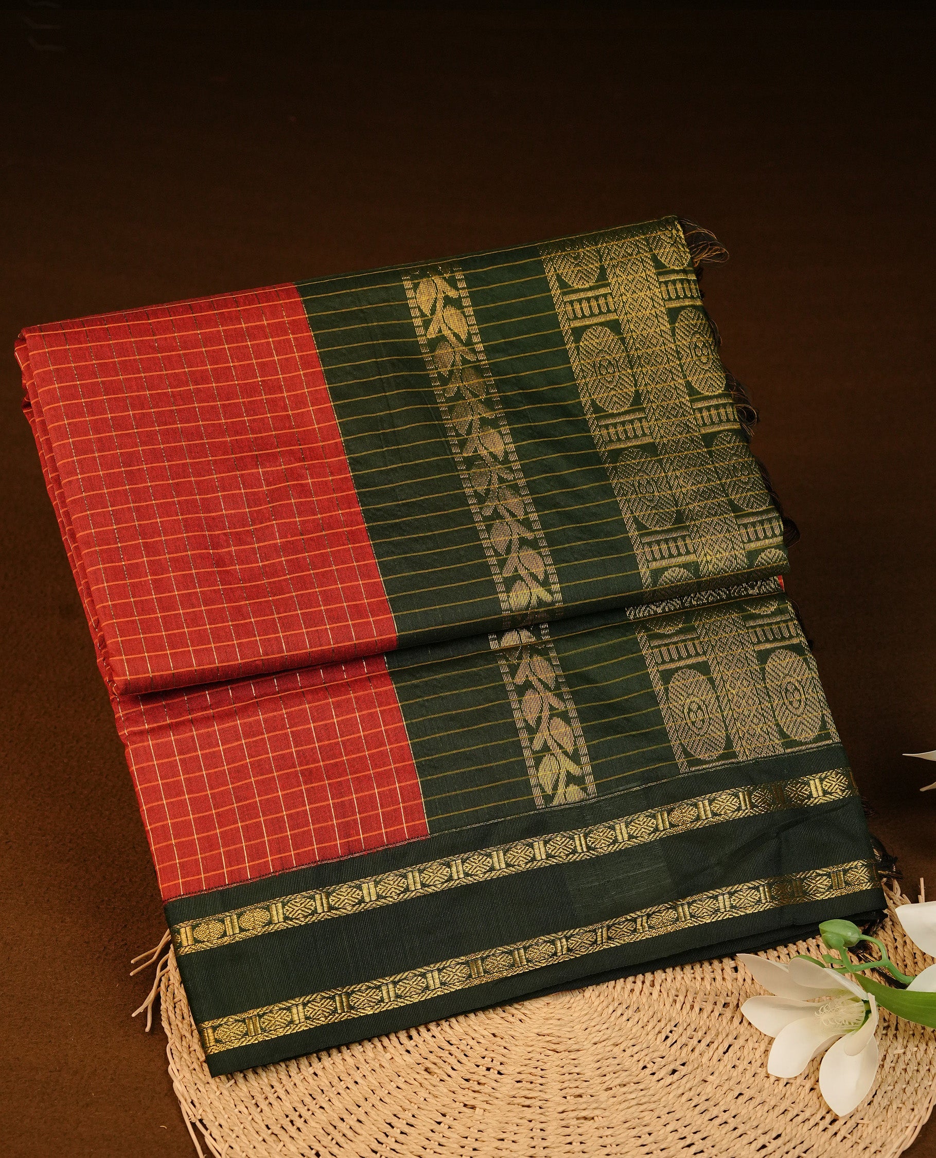 Maroon colour Kalyani cotton saree featuring Gold zari check pattern on body, complemented by Contrast Green colour with grand gold zari border & pallu, matching blouse piece
