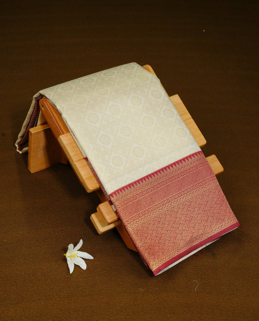 Cream Colour Semi Soft Silk Saree Featuring Gold zari Box With motifs Pattern On Body, Highlighted  by contrast Maroon border with Gold zari, paired with matching blouse piece.